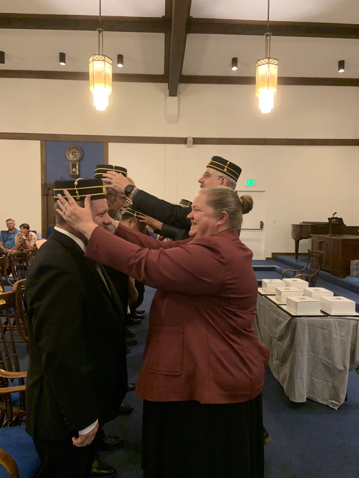 Spouses and family members placing Scottish Rite caps on the newest members