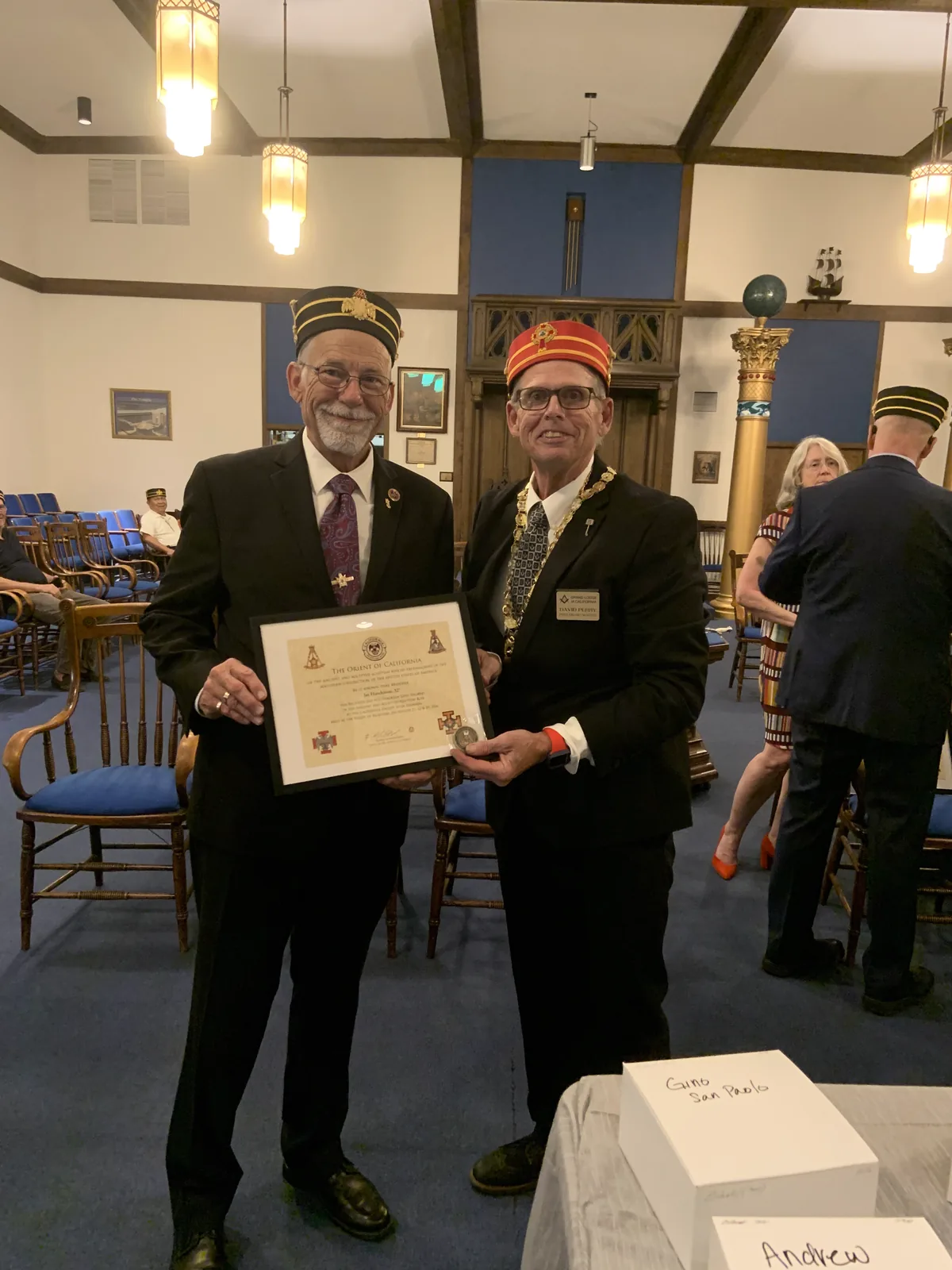 The Personal Representative presenting a certificate and coin to a candidate