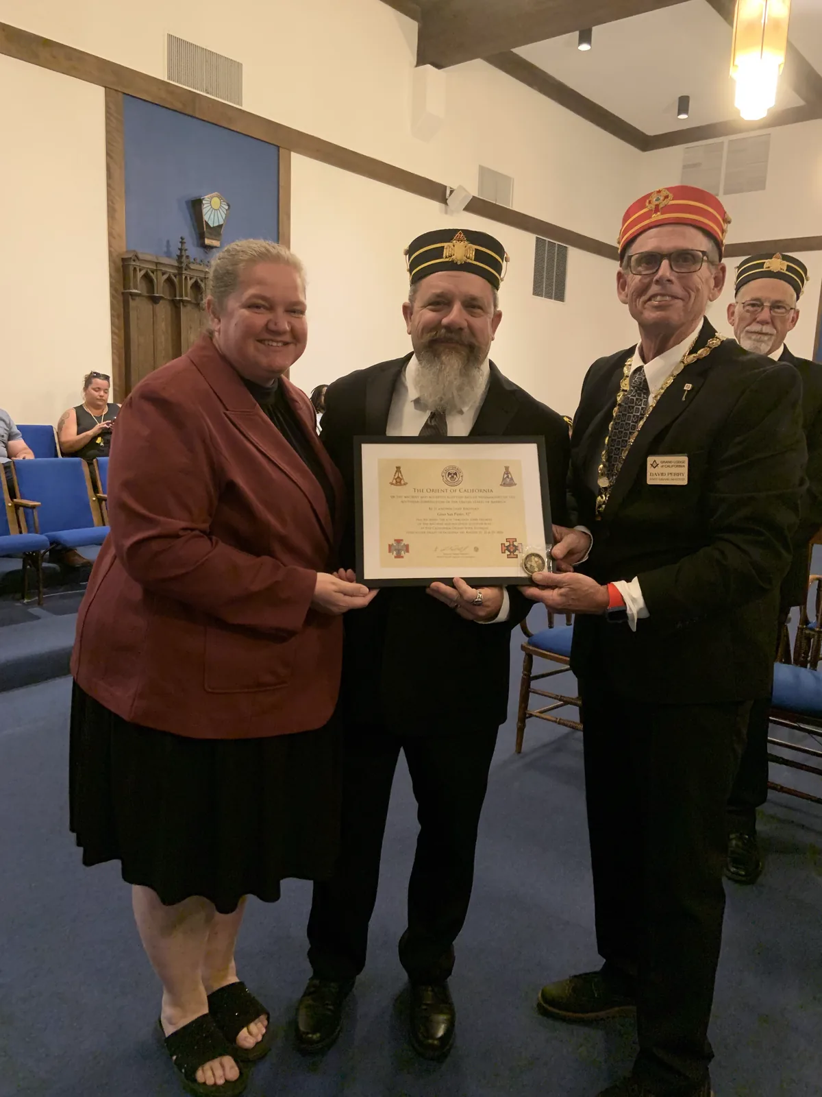 A new member and his wife holding his Scottish Rite certificate