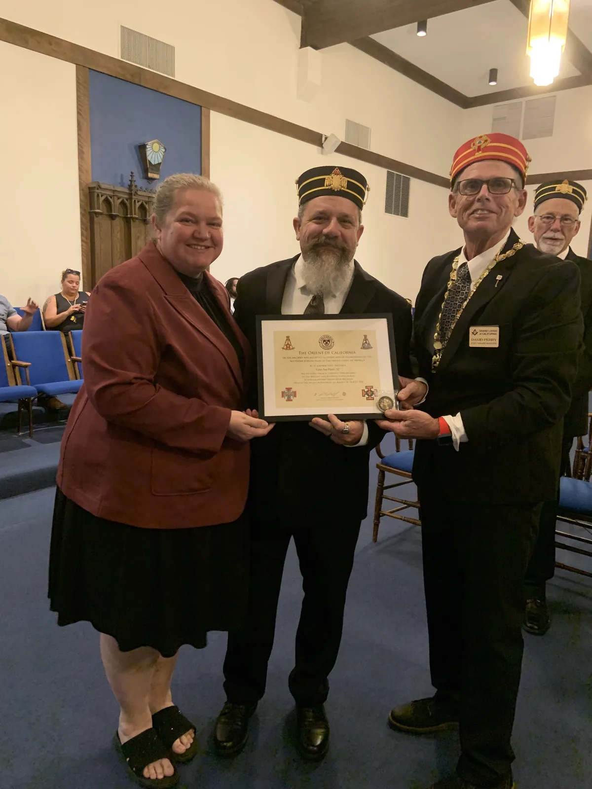 A new member's certificate presented alongside his wife